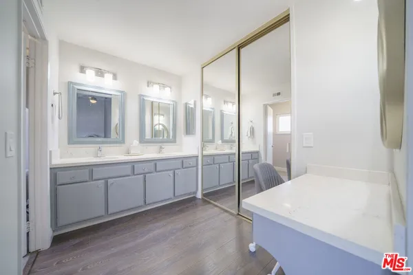 a spacious bathroom with a granite countertop sink mirror and a shower