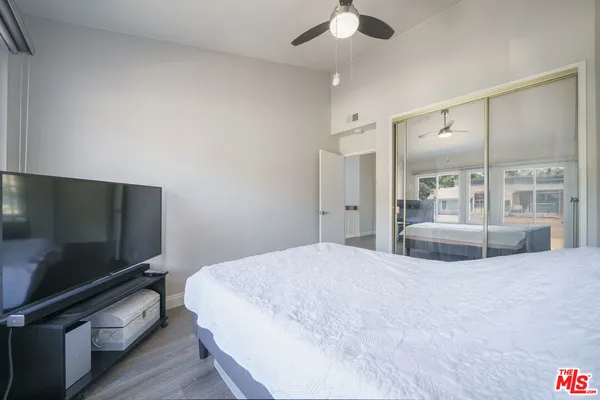 a bedroom with a bed and a flat screen tv