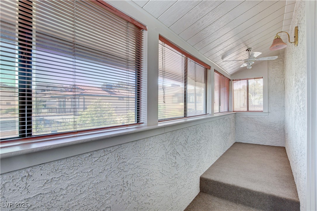 845 Robinson Lane Boulder City, NV 89005 - Photo 59 of 66 Unfurnished sunroom featuring lofted ceiling, a textured wall, and carpet