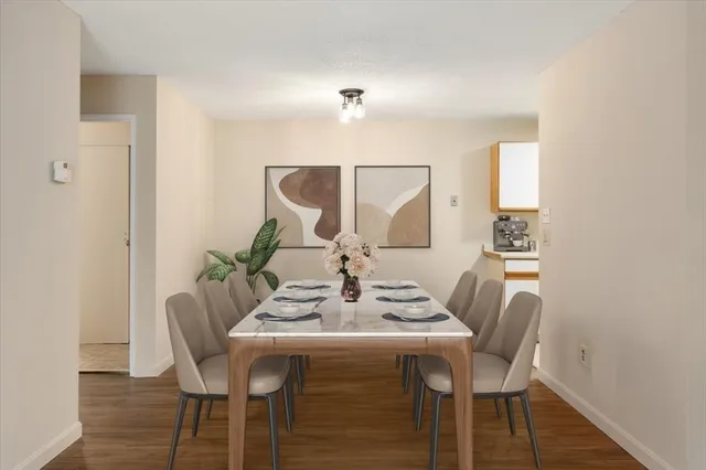 a view of a dining room with furniture and wooden floor
