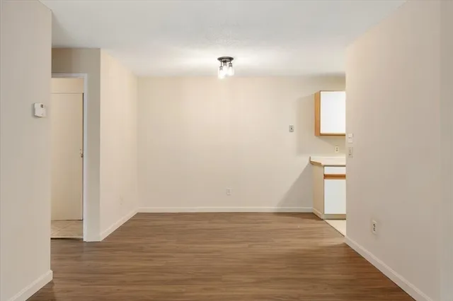 a view of a room with wooden floor and a ceiling fan