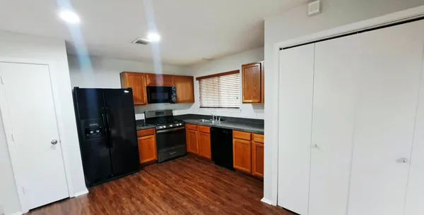 a kitchen with stainless steel appliances granite countertop a refrigerator and a sink