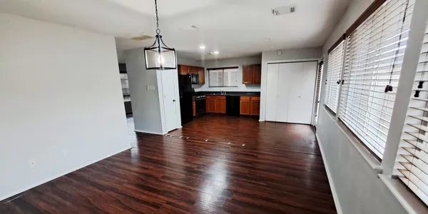 a view of a kitchen with wooden floor and a kitchen
