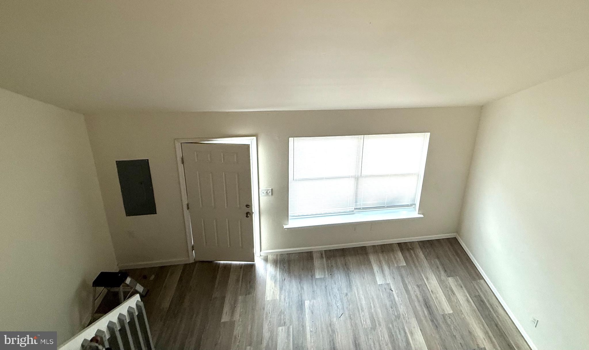 124 Spruance Road Dover, DE 19901 - Photo 6 of 17 an empty room with wooden floor and a window