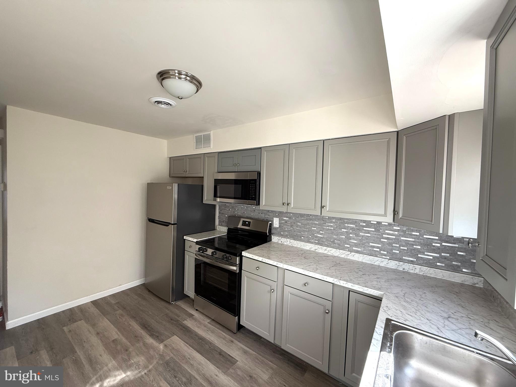 124 Spruance Road Dover, DE 19901 - Photo 8 of 17 a kitchen with stainless steel appliances granite countertop a sink and cabinets
