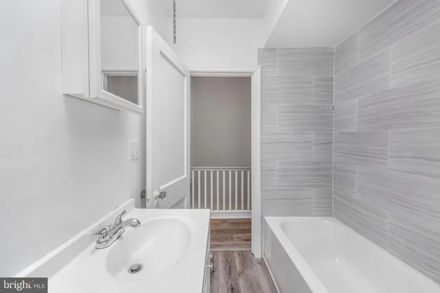 a bathroom with a tub and sink