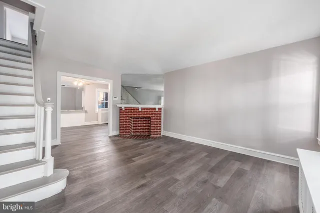 a view of an empty room and wooden floor