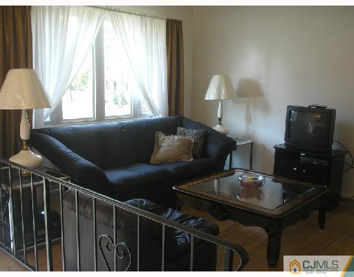 35 Warrenville Road Middlesex, NJ 08846 - Photo 2 of 10 a living room with furniture and a window