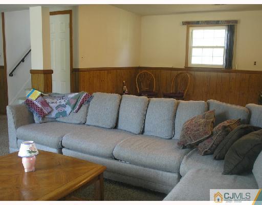 35 Warrenville Road Middlesex, NJ 08846 - Photo 5 of 10 a living room with a couch