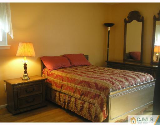 35 Warrenville Road Middlesex, NJ 08846 - Photo 7 of 10 a bedroom with a bed and teddy bear on bed