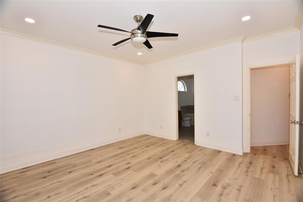 1503 Natural Bridge Lane Pflugerville, TX 78660 - Photo 15 of 20 an empty room with a ceiling fan and wooden floor
