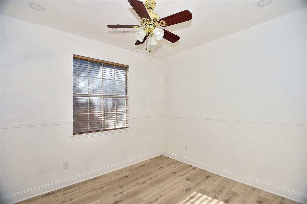 1503 Natural Bridge Lane Pflugerville, TX 78660 - Photo 4 of 20 an empty room with a window and a fan