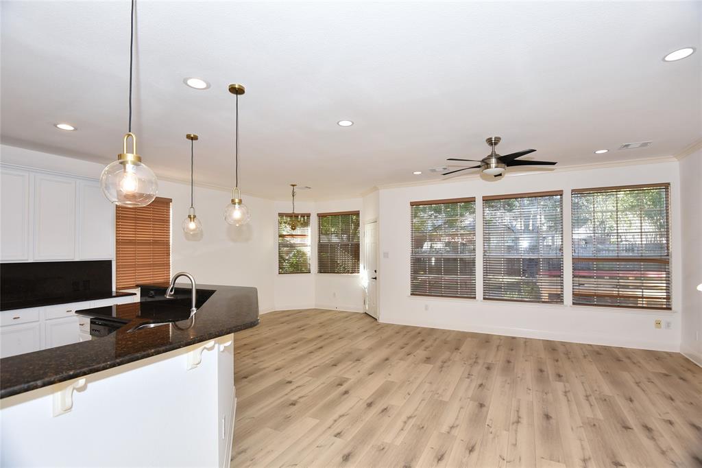 1503 Natural Bridge Lane Pflugerville, TX 78660 - Photo 7 of 20 a view of a kitchen with a sink and a wooden floor