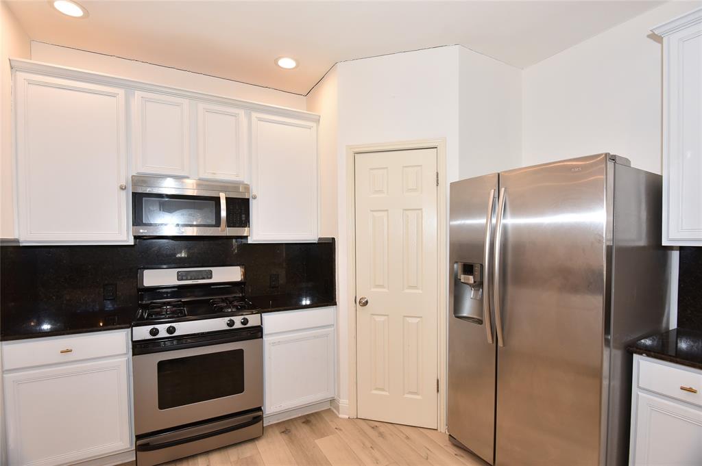 1503 Natural Bridge Lane Pflugerville, TX 78660 - Photo 10 of 20 a kitchen with a refrigerator stove and microwave