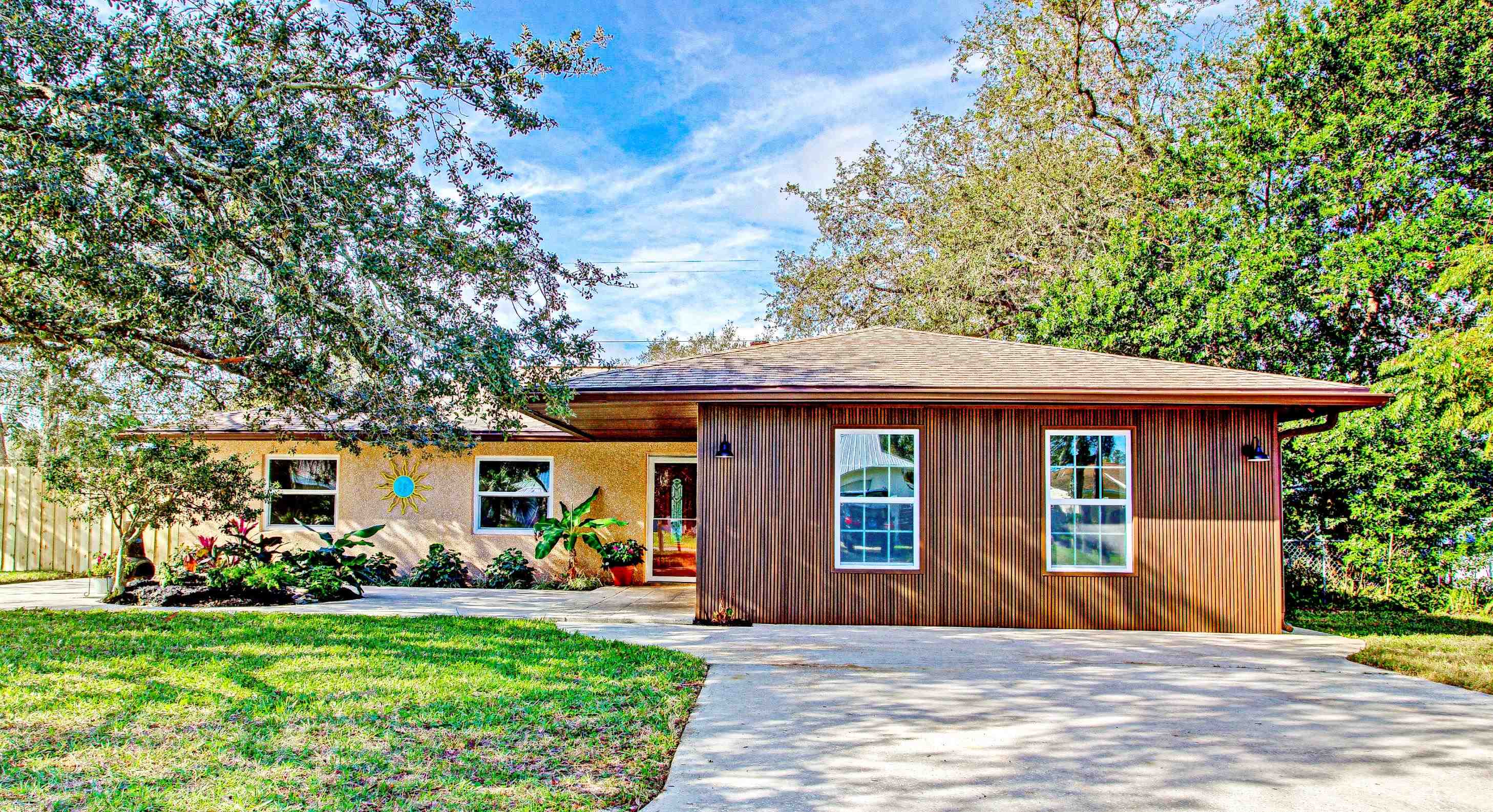 412 Gentian Road St. Augustine, FL 32086 - Photo 1 of 58 a front view of a house with a garden