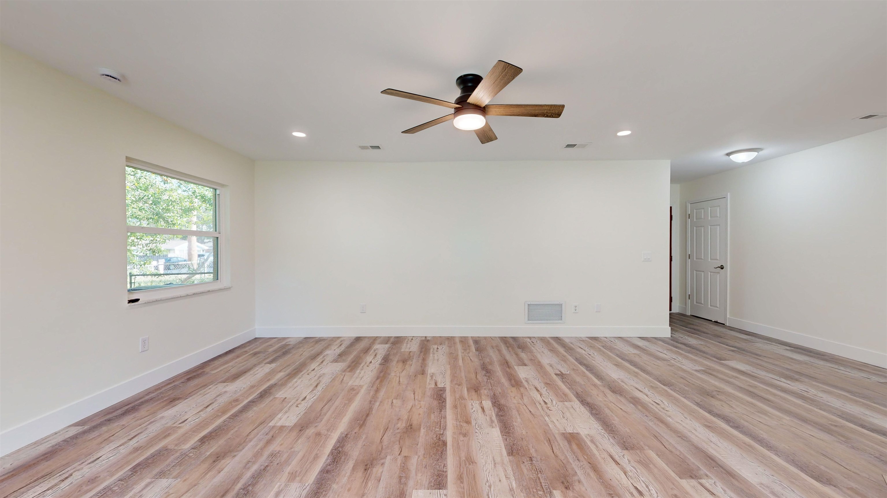 412 Gentian Road St. Augustine, FL 32086 - Photo 18 of 58 an empty room with wooden floor a ceiling fan and windows