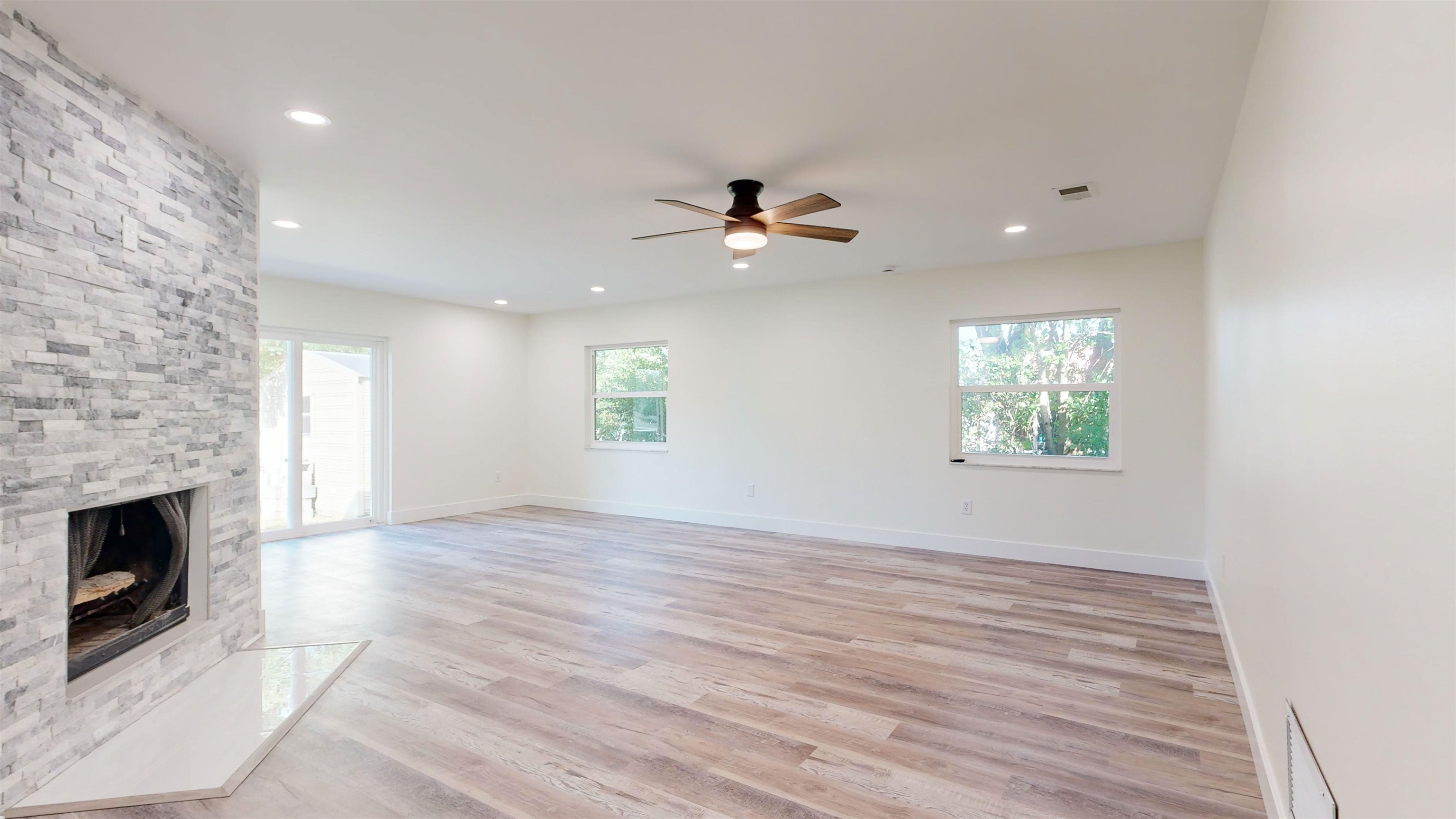 412 Gentian Road St. Augustine, FL 32086 - Photo 19 of 58 an empty room with windows and a fireplace
