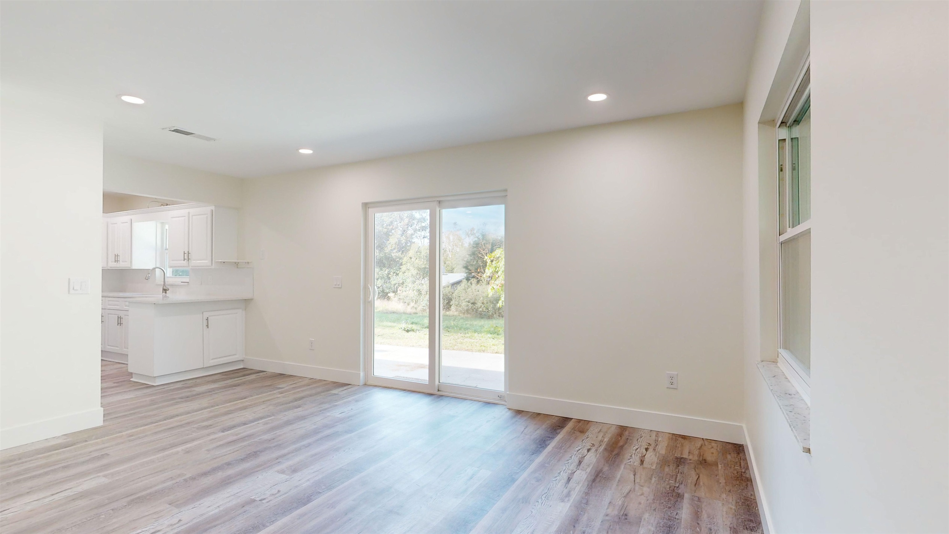 412 Gentian Road St. Augustine, FL 32086 - Photo 22 of 58 a view of an empty room with wooden floor and a window