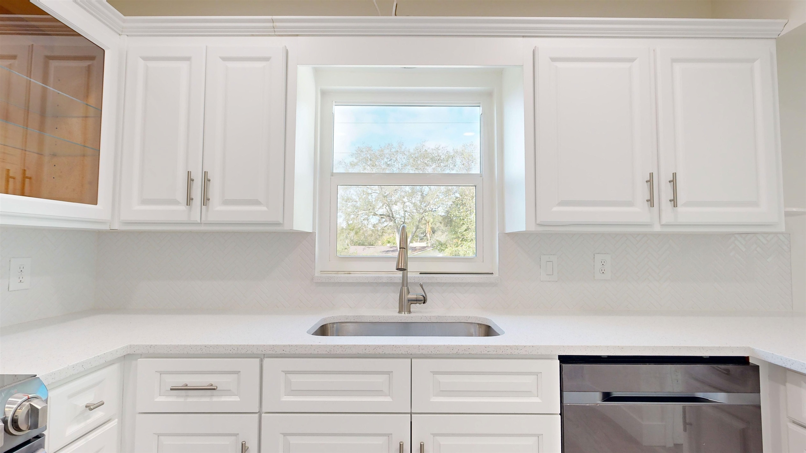 412 Gentian Road St. Augustine, FL 32086 - Photo 25 of 58 a kitchen with white cabinets and a window