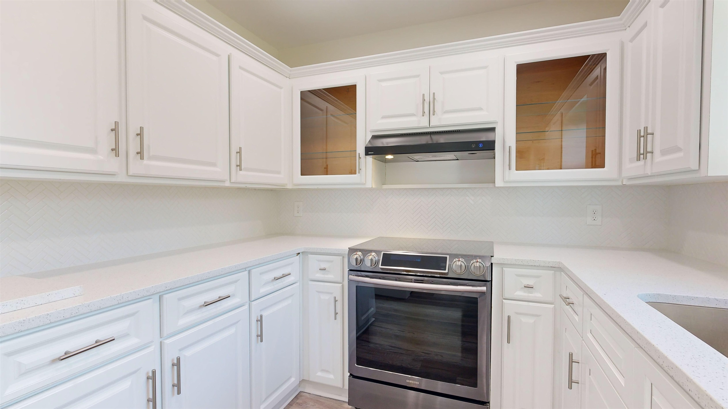 412 Gentian Road St. Augustine, FL 32086 - Photo 26 of 58 a kitchen with white cabinets and white appliances