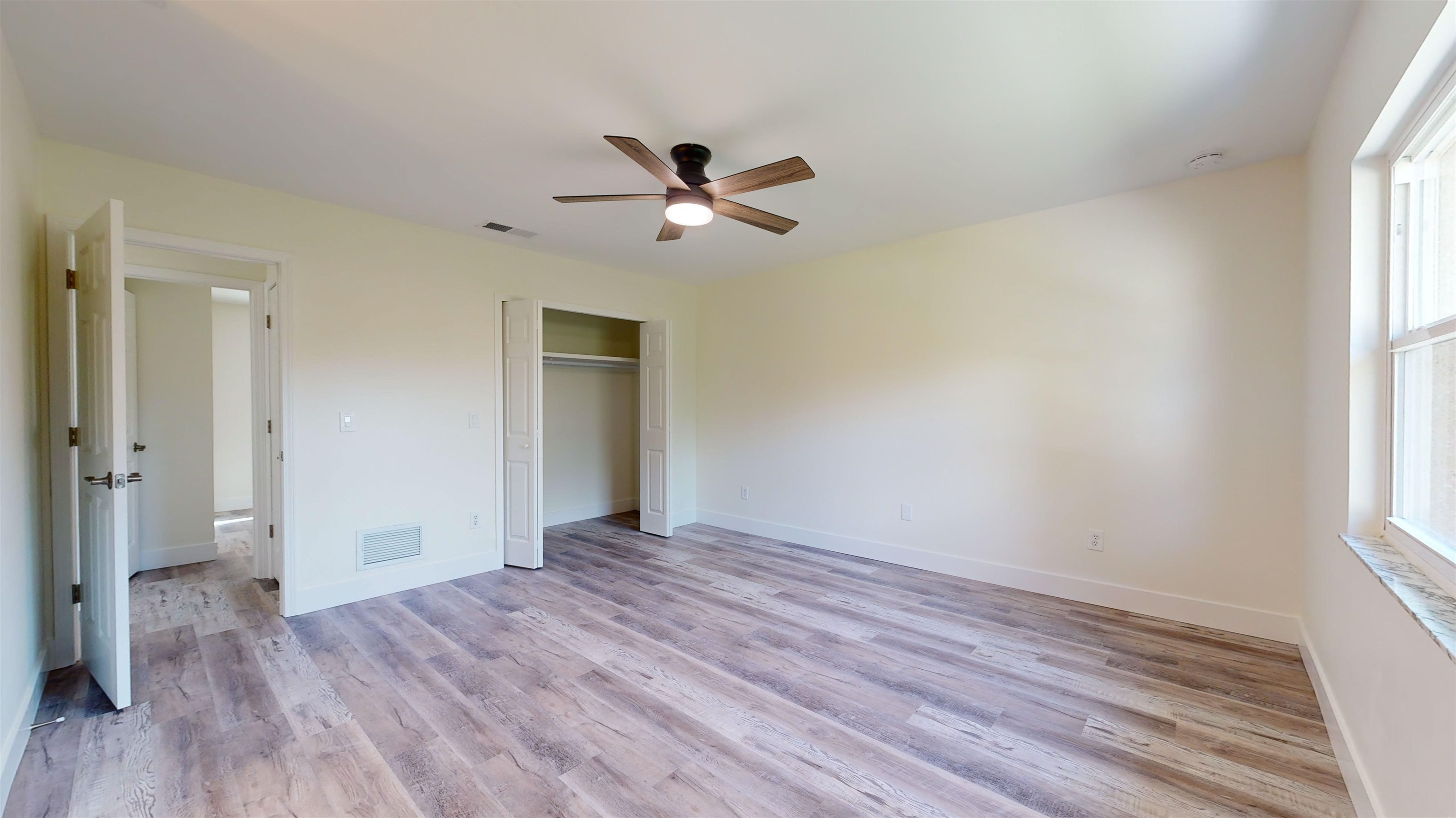 412 Gentian Road St. Augustine, FL 32086 - Photo 27 of 58 a view of empty room with wooden floor and fan