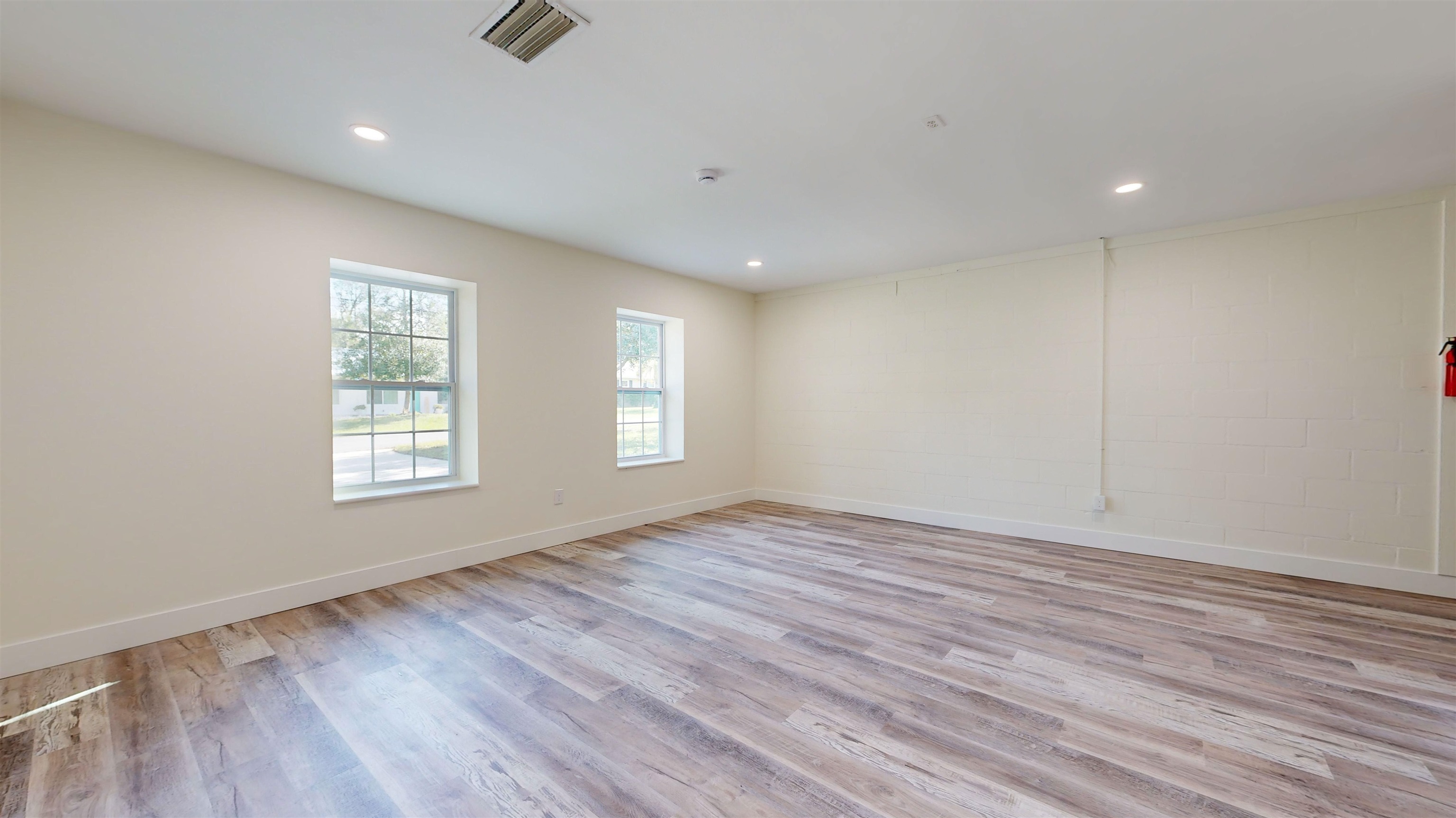 412 Gentian Road St. Augustine, FL 32086 - Photo 33 of 58 an empty room with wooden floor and windows