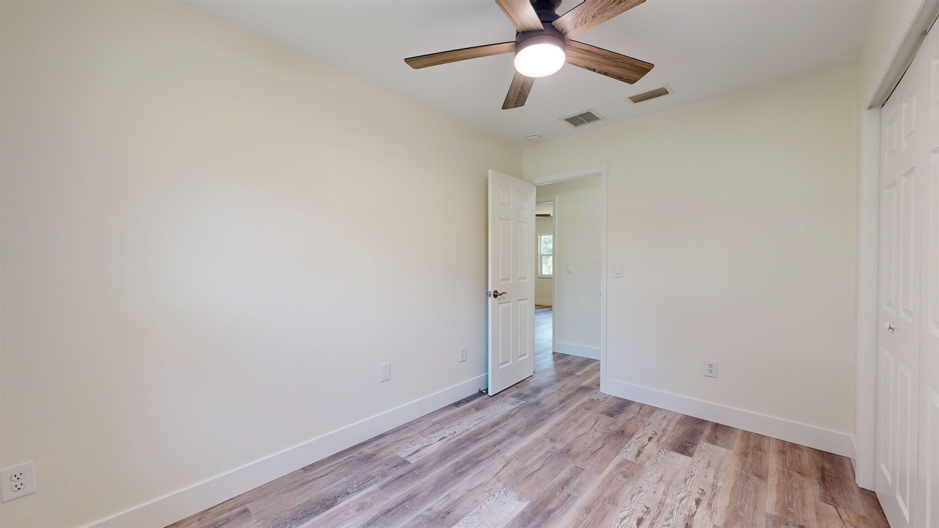 412 Gentian Road St. Augustine, FL 32086 - Photo 39 of 58 an empty room with wooden floor and a ceiling fan