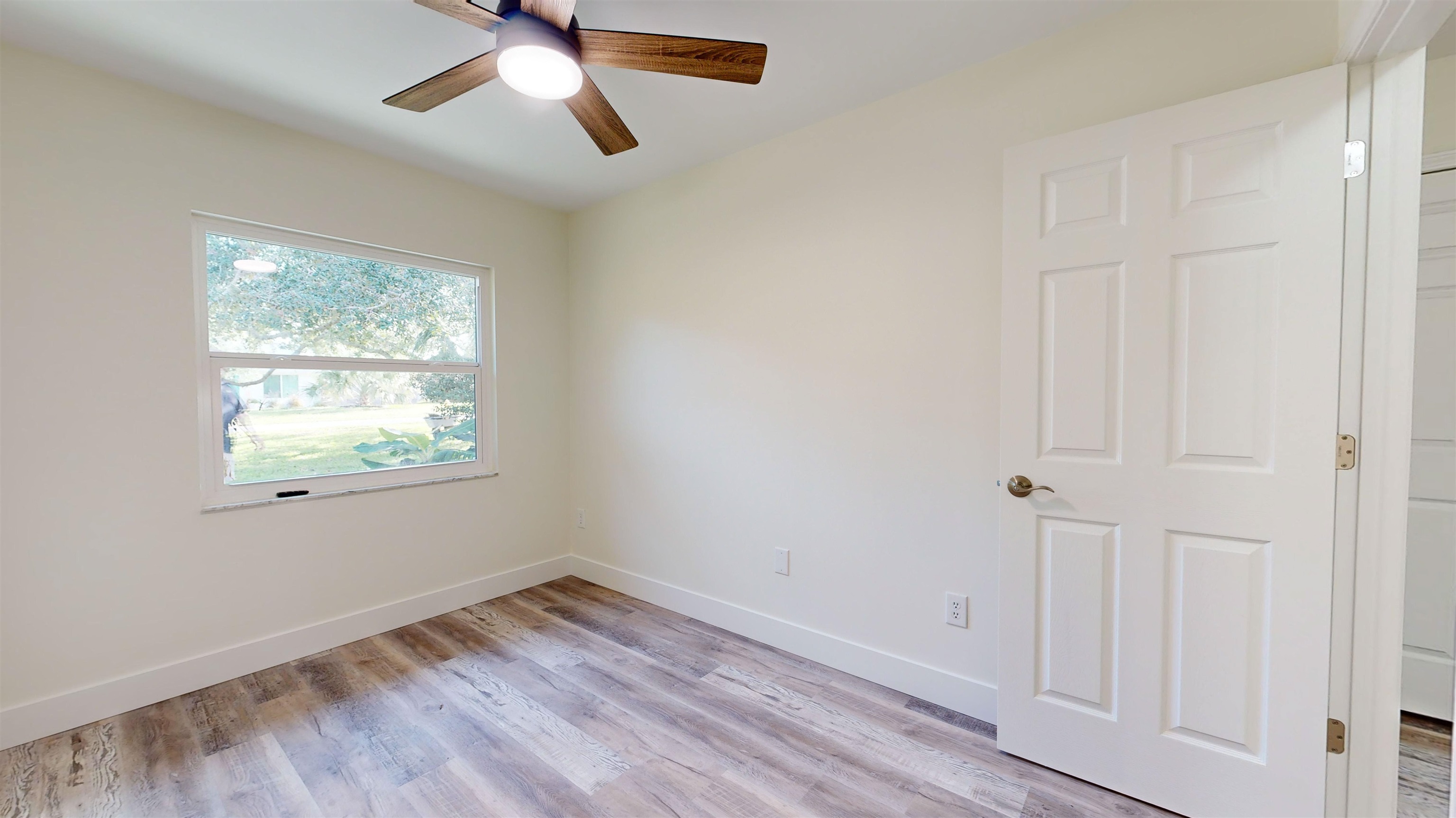 412 Gentian Road St. Augustine, FL 32086 - Photo 40 of 58 a view of empty room with wooden floor and fan