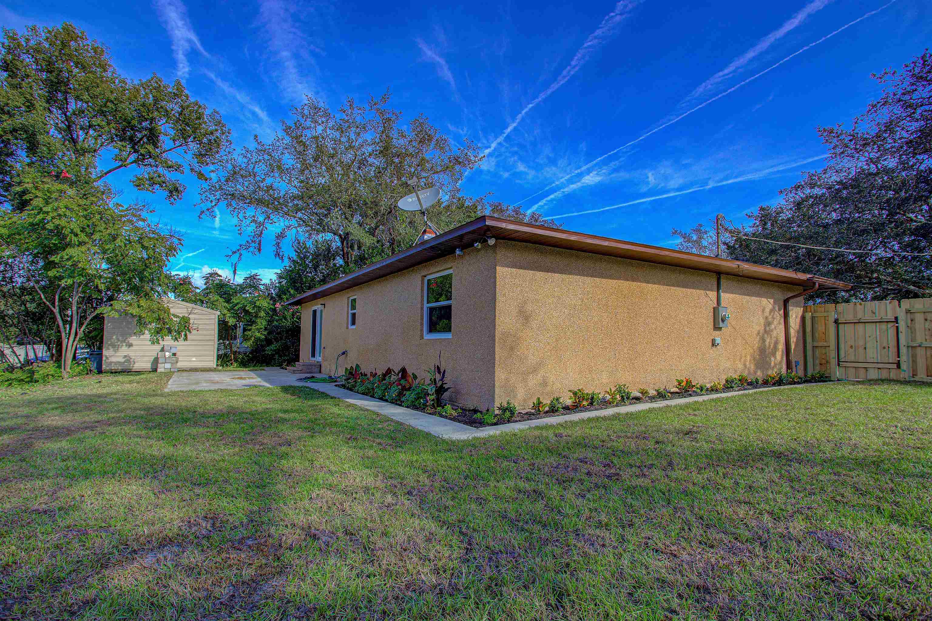 412 Gentian Road St. Augustine, FL 32086 - Photo 49 of 58 a view of a backyard with potted plants and large trees