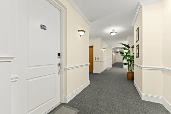 a view of a hallway with wooden shelves