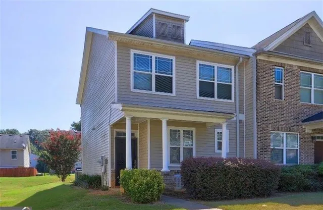 front view of a brick house with a yard