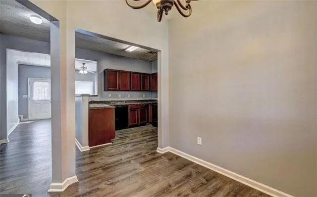a view of a kitchen with a sink and a refrigerator