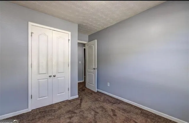 an empty room with closet area