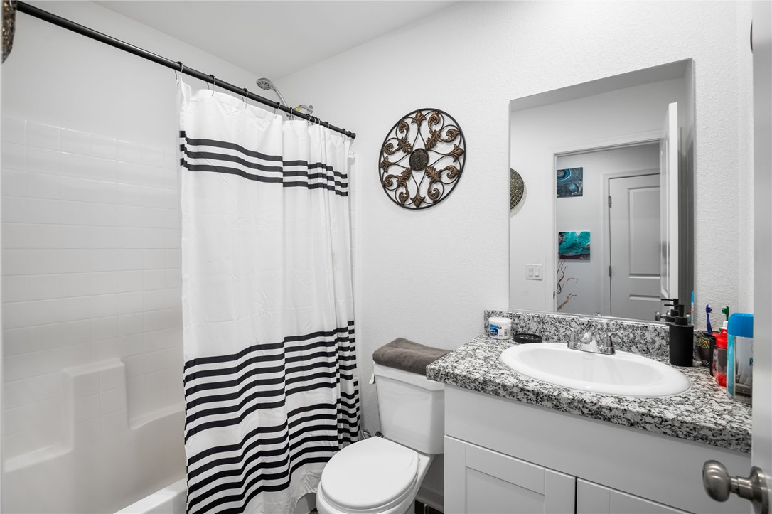 3623 East Andrea Drive Kingman, AZ 86409 - Photo 20 of 40 Guest Bathroom featuring a white vanity with a granite countertop and an undermount sink