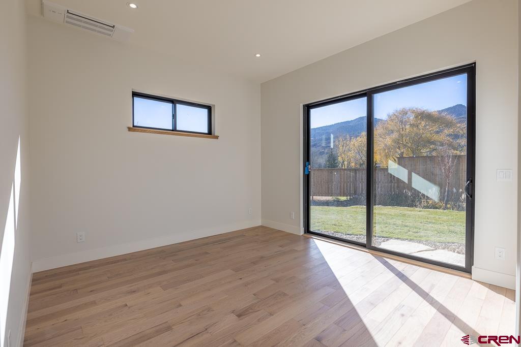 45 West Dalton Road Durango, CO 81301 - Photo 24 of 43 a view of an empty room with wooden floor and a large window