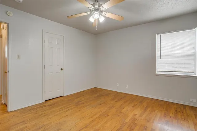a view of a big room with wooden floor and windows in a room