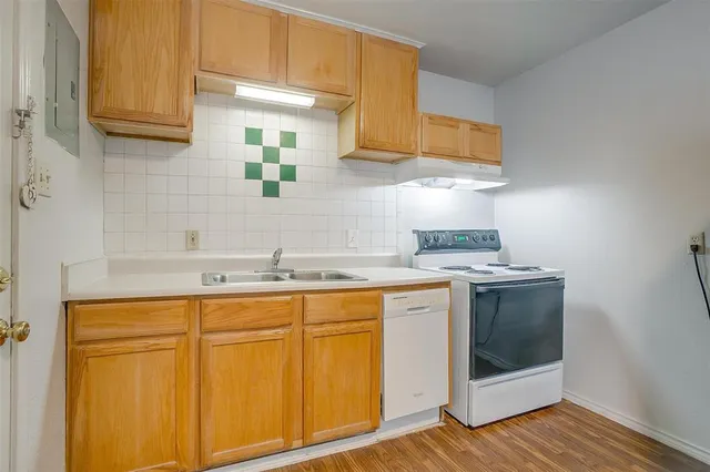 a kitchen with stainless steel appliances granite countertop a sink and a stove