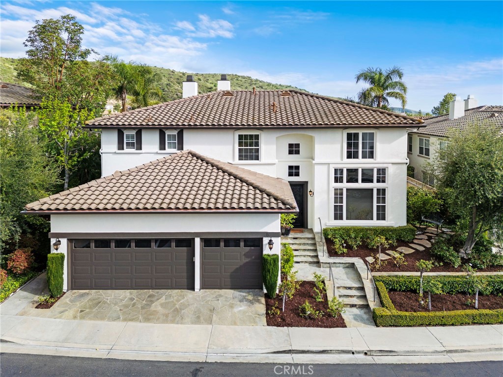 5 Golf Ridge Drive Rancho Santa Margarita, CA 92679 - Photo 1 of 1 a front view of a house with garden