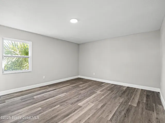a view of room with window and hardwood floor