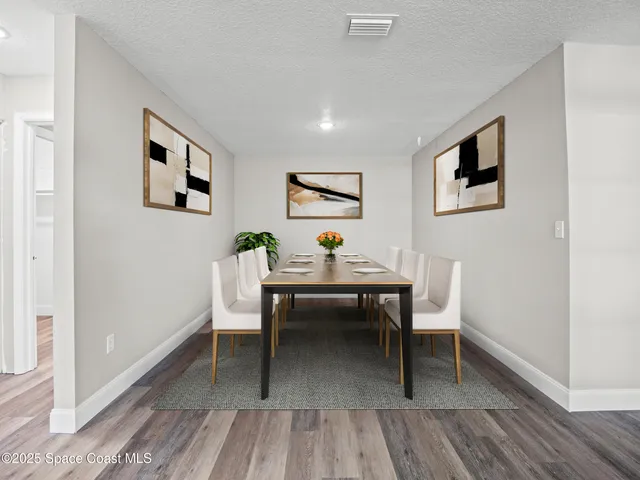a view of a livingroom with furniture and wooden floor