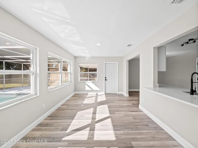 a view of a house with a lounge chair and a large window