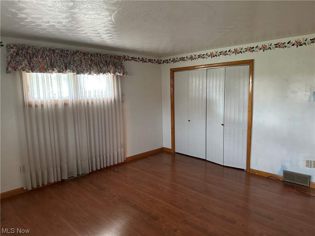62273 Tacoma Road Barnesville, OH 43713 - Photo 23 of 34 Spare room featuring hardwood floors