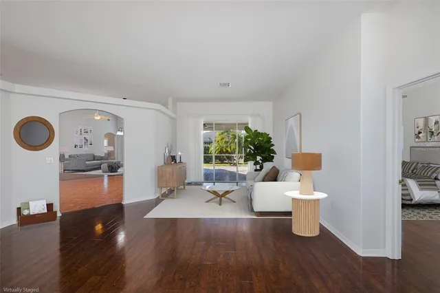 a living room with furniture and a wooden floor
