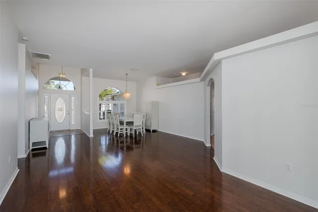 a dining room with furniture and wooden floor