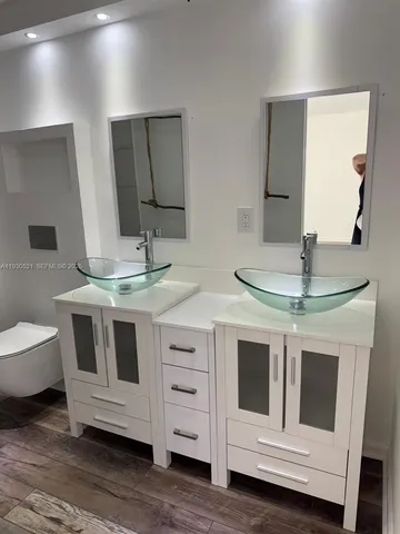 a bathroom with a double vanity sink and mirror