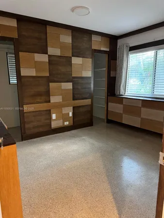 a view of room with window and cabinet
