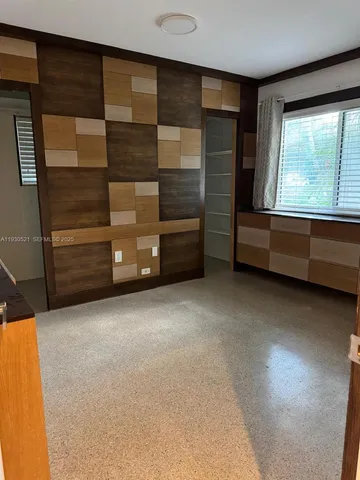 a view of room with window and cabinet