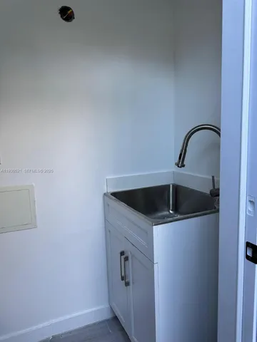 a close view of a sink and washer in a kitchen