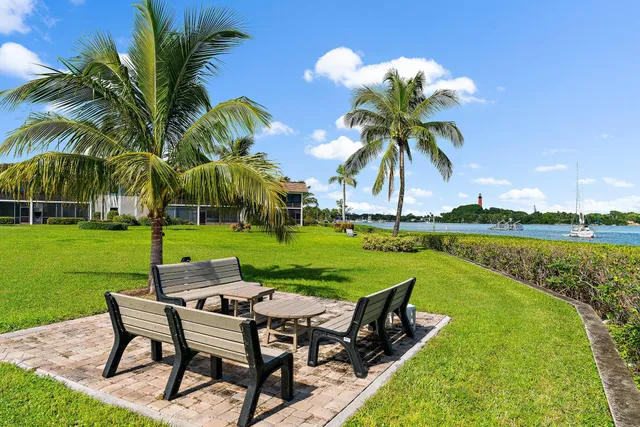 a view of a lake with a table and chairs