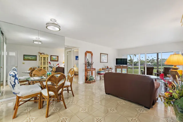 a living room filled with furniture and a large window